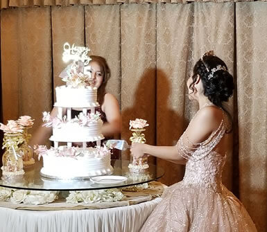 wedding cake with the bride beside it
